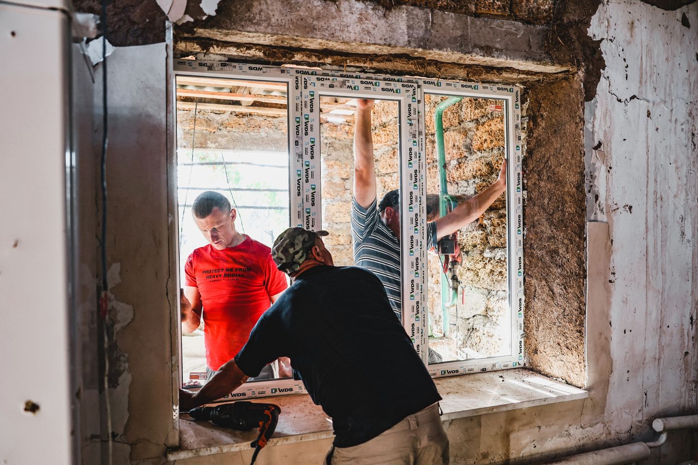 Volunteers Putting In New Window Frame Volunteers Putting In New Window Frame