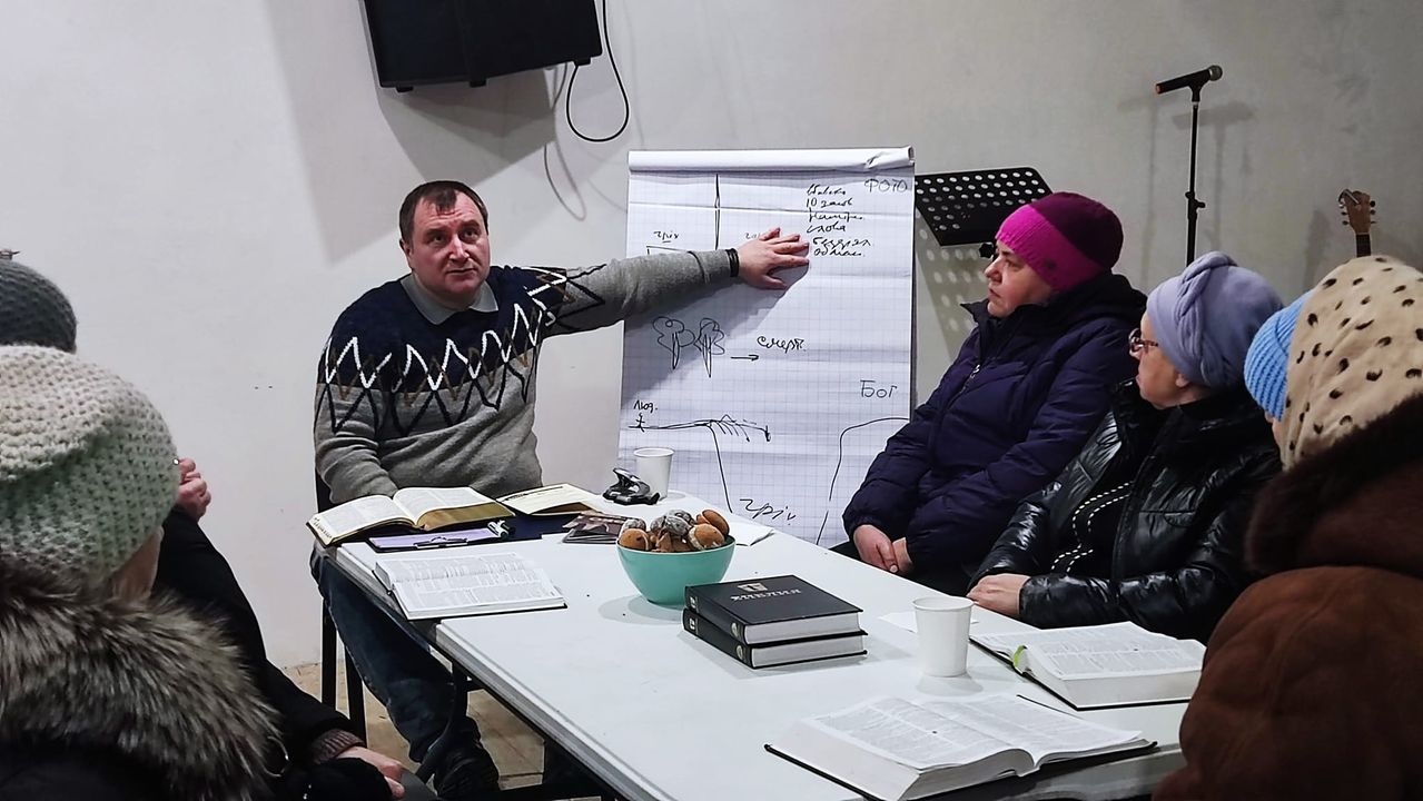 Pastor Explaining Through Whiteboard To The Bible Group Jan