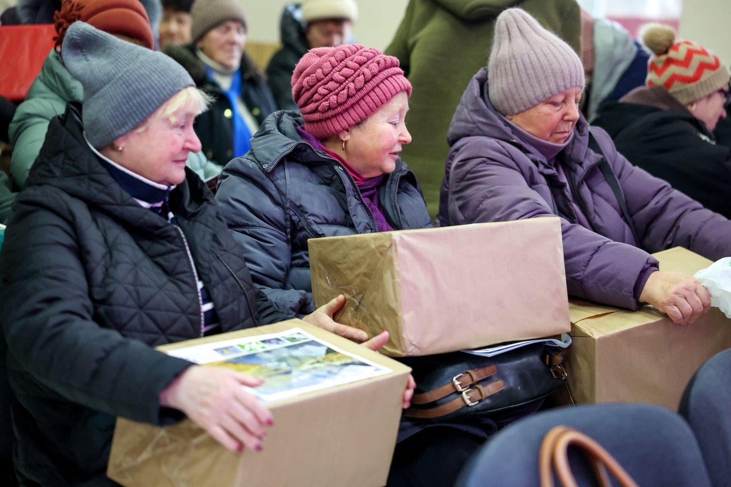 Senior Women Sitting In A Row With Their Christmas Presents Senior Women Sitting In A Row With Their Christmas Presents