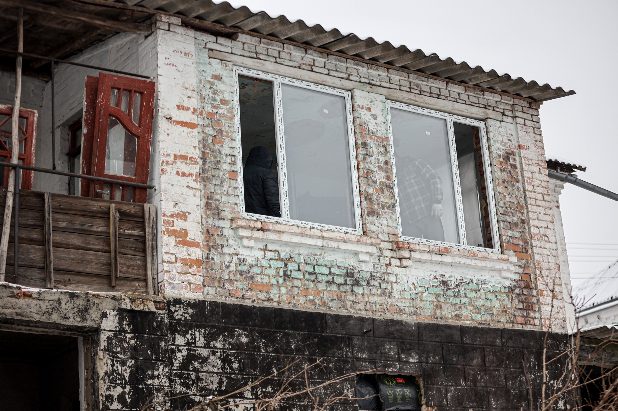 The Damaged Facade Of A Building Getting New Windows In Kherson