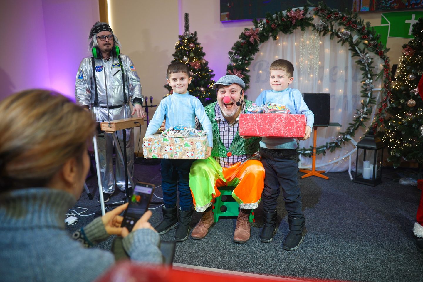 Two Ukrainian Boys Getting A Picture With An Entertainer With Clown Nose Two Ukrainian Boys Getting A Picture With An Entertainer With Clown Nose
