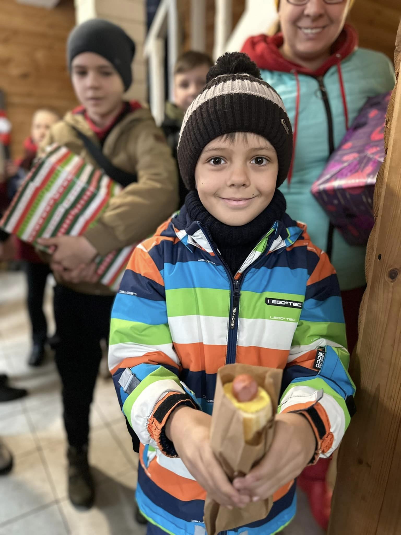 Ukrainian Boy Holding A Hot Dog Given Out By Volunteers Ukrainian Boy Holding A Hot Dog Given Out By Volunteers