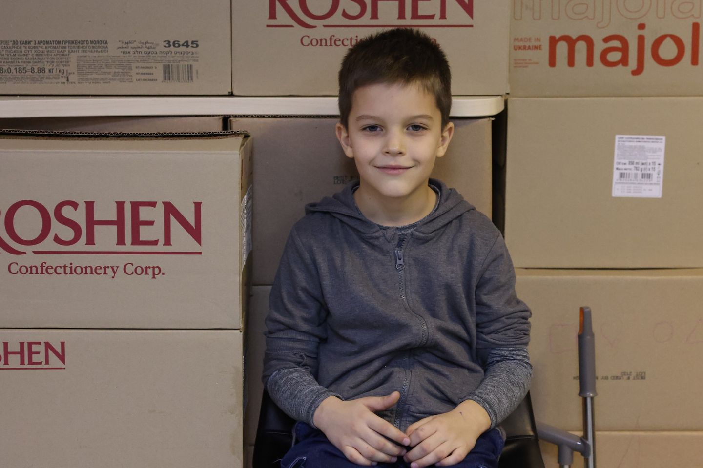 Ukrainian Boy Sitting By Boxes Of Kherson Aid Ukrainian Boy Sitting By Boxes Of Kherson Aid