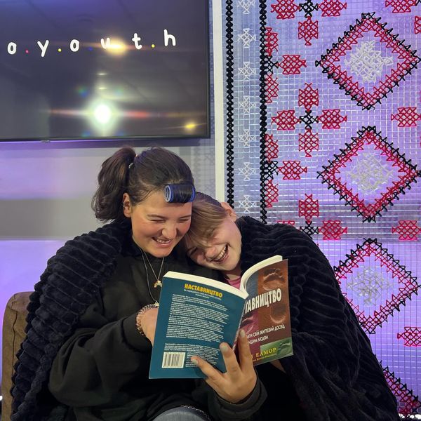 Woman Reading A Book To A Young Girl During Uouth Group Woman Reading A Book To A Young Girl During Uouth Group