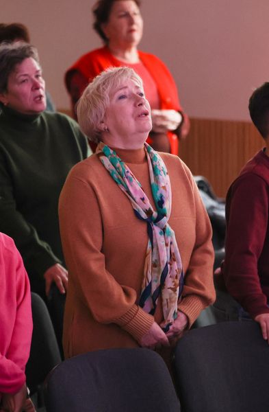 Woman Singing During The Worship Section Of The Sunday Service Woman Singing During The Worship Section Of The Sunday Service