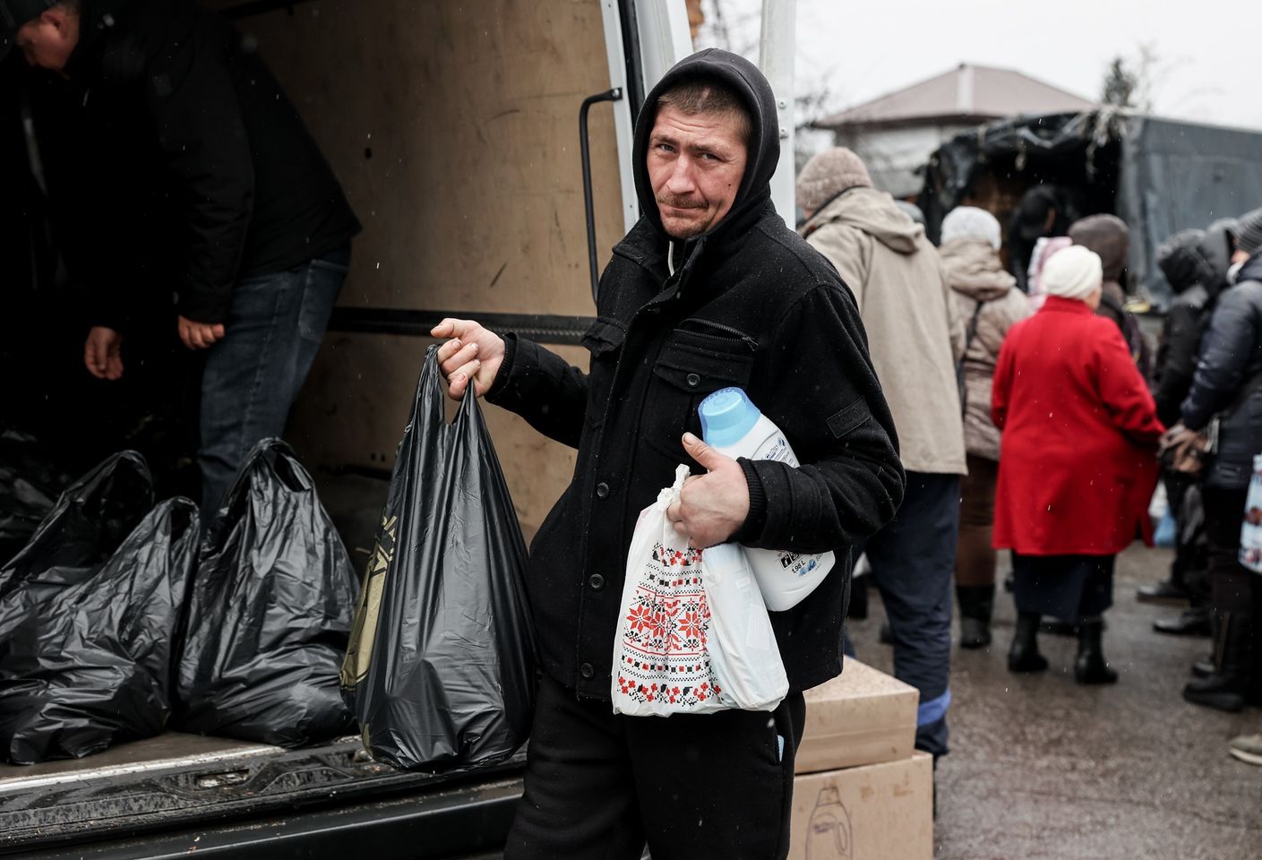A Ukrainian Man Holds Multiple Bags Of Essential Goods A Ukrainian Man Holds Multiple Bags Of Essential Goods