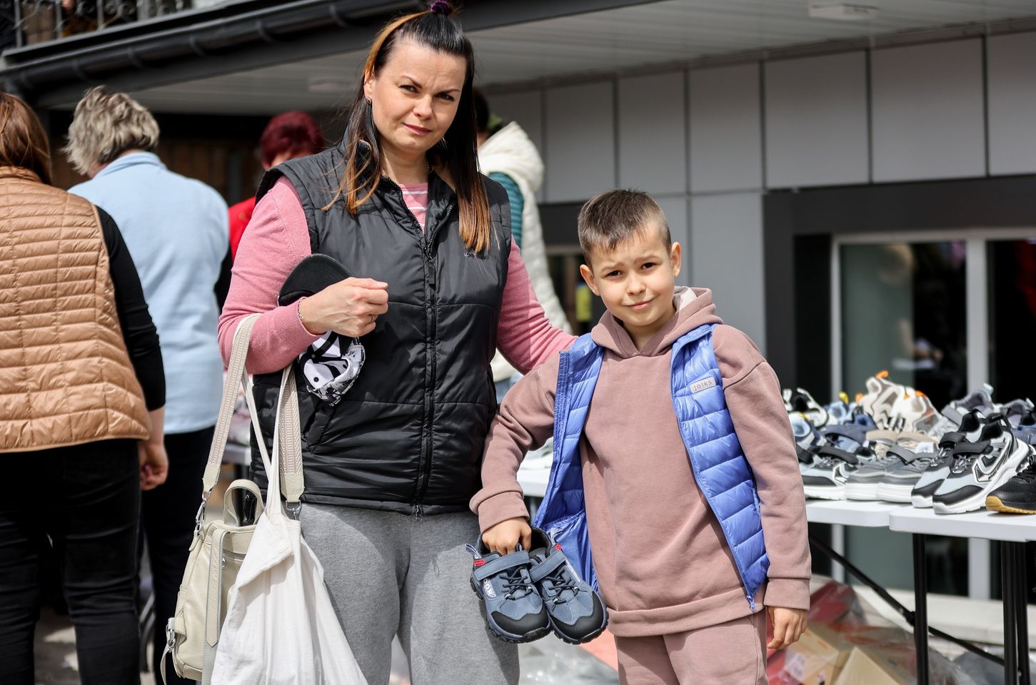 A Ukrainian Woman With Her Son With Shoes They Have Gotten From A Distribution A Ukrainian Woman With Her Son With Shoes They Have Gotten From A Distribution