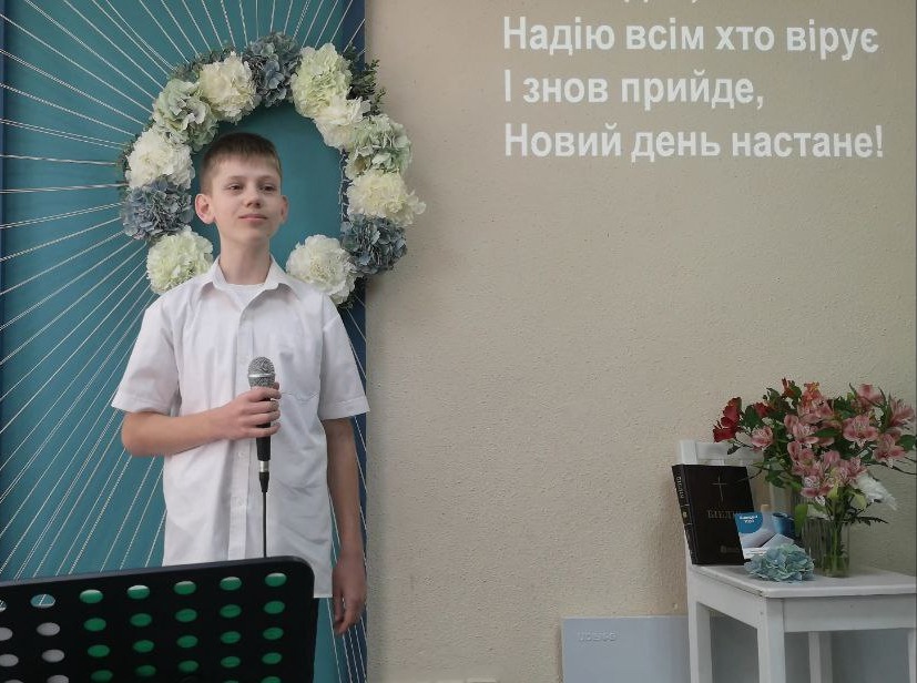 Ukrainian Boy Speaking Into Microphone In Front Of Congregation Ukrainian Boy Speaking Into Microphone In Front Of Congregation