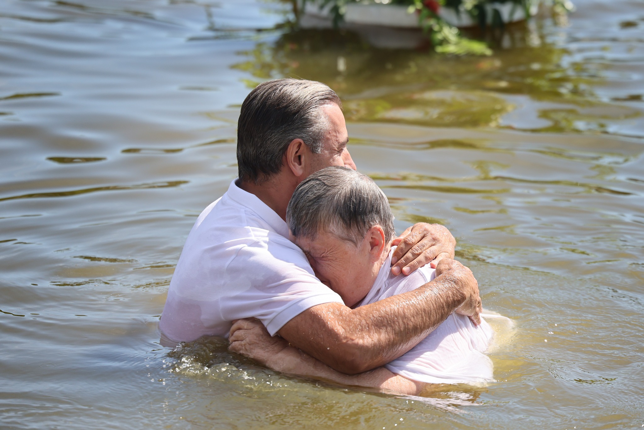 Elderly Ukrainian Woman Hugging Pastor After Baptism Elderly Ukrainian Woman Hugging Pastor After Baptism