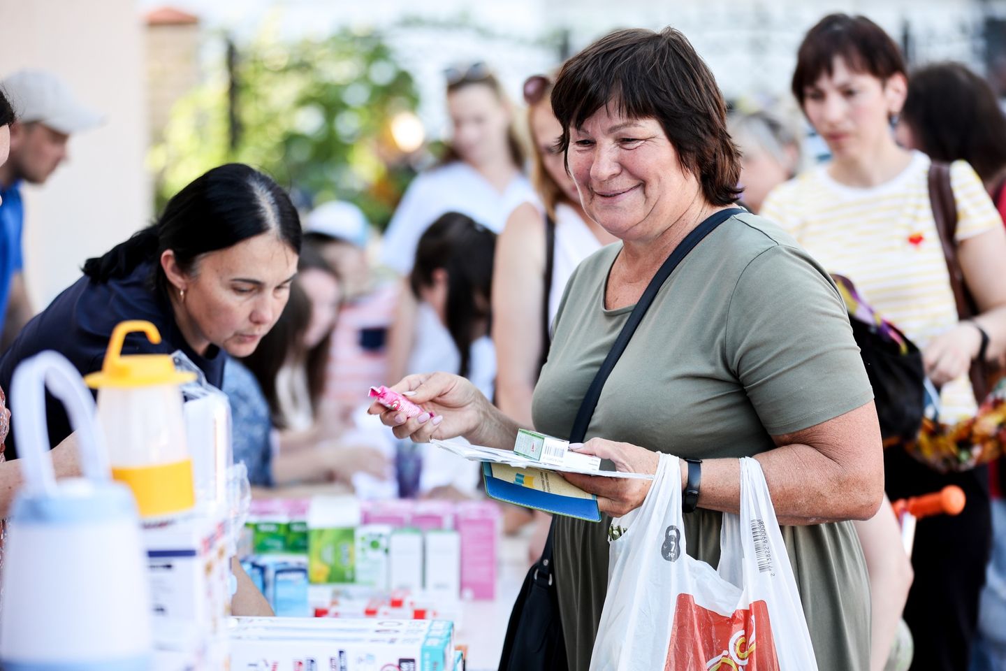 Ukrainian Woman Smiling With Bag Of Vital Supplies Ukrainian Woman Smiling With Bag Of Vital Supplies