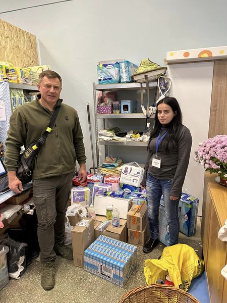 Ukrainian Man And Woman Stand In Filled Up Humanitarian Hub Ukrainian Man And Woman Stand In Filled Up Humanitarian Hub
