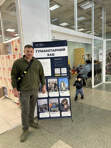 Ukrainian Man Stands In Front Of A Sign That Says % Humanitarian Hub% Nov Ukrainian Man Stands In Front Of A Sign That Says % Humanitarian Hub% Nov