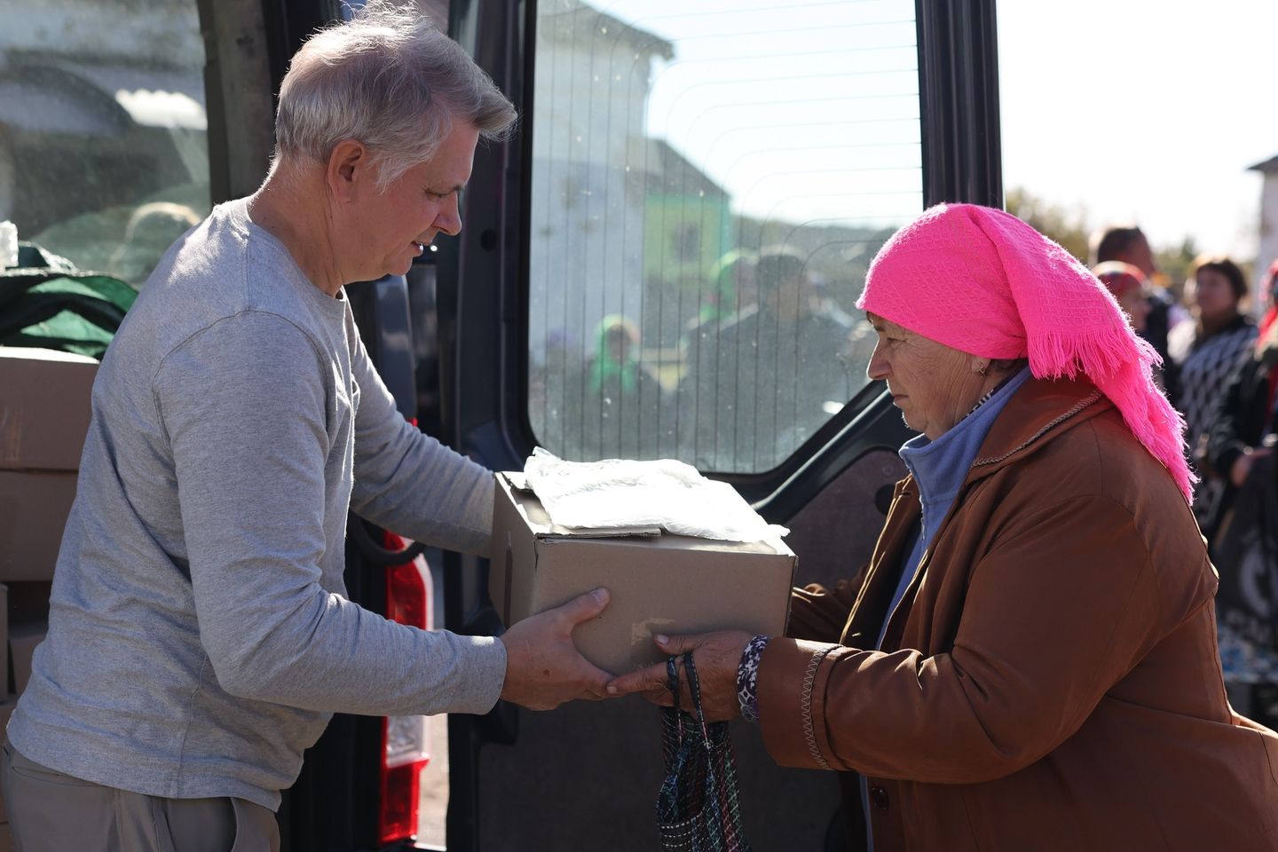Kyiv Church pastor handing box to one of the Ukrainian villagers N