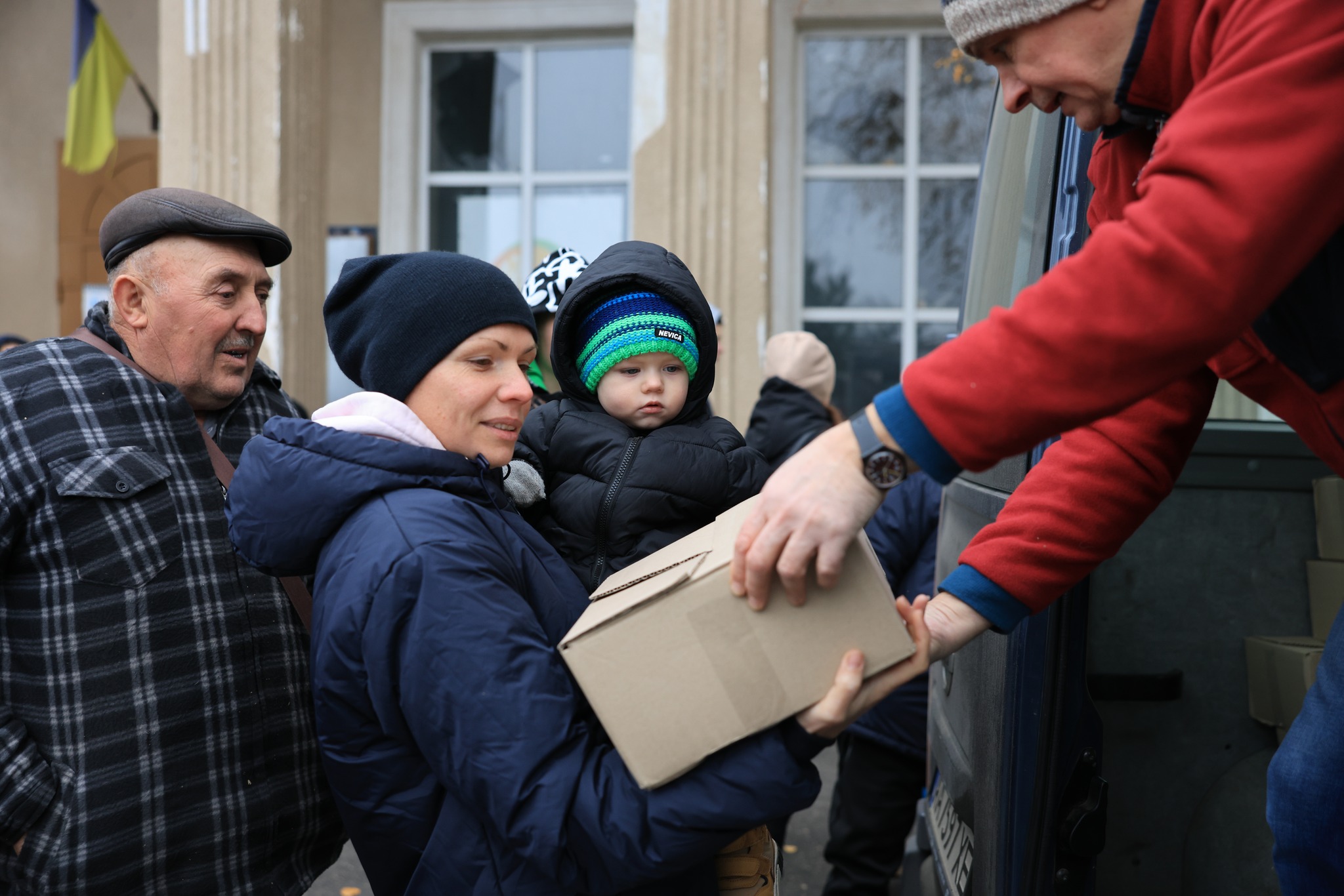 Ukrainian Woman With A Baby Receiving A Package Ukrainian Woman With A Baby Receiving A Package
