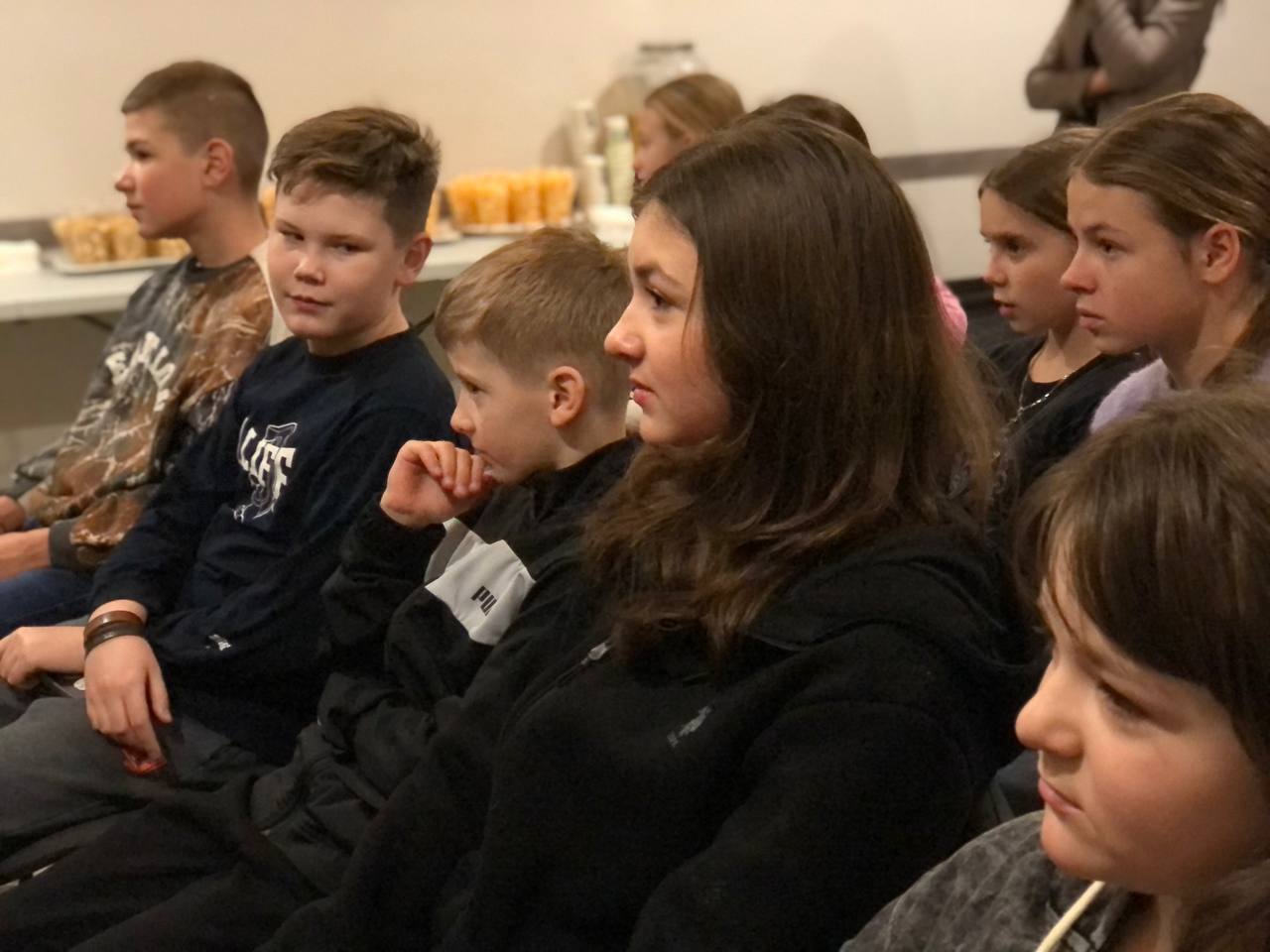 Kids Listening To A Speaker At An Event Kids Listening To A Speaker At An Event