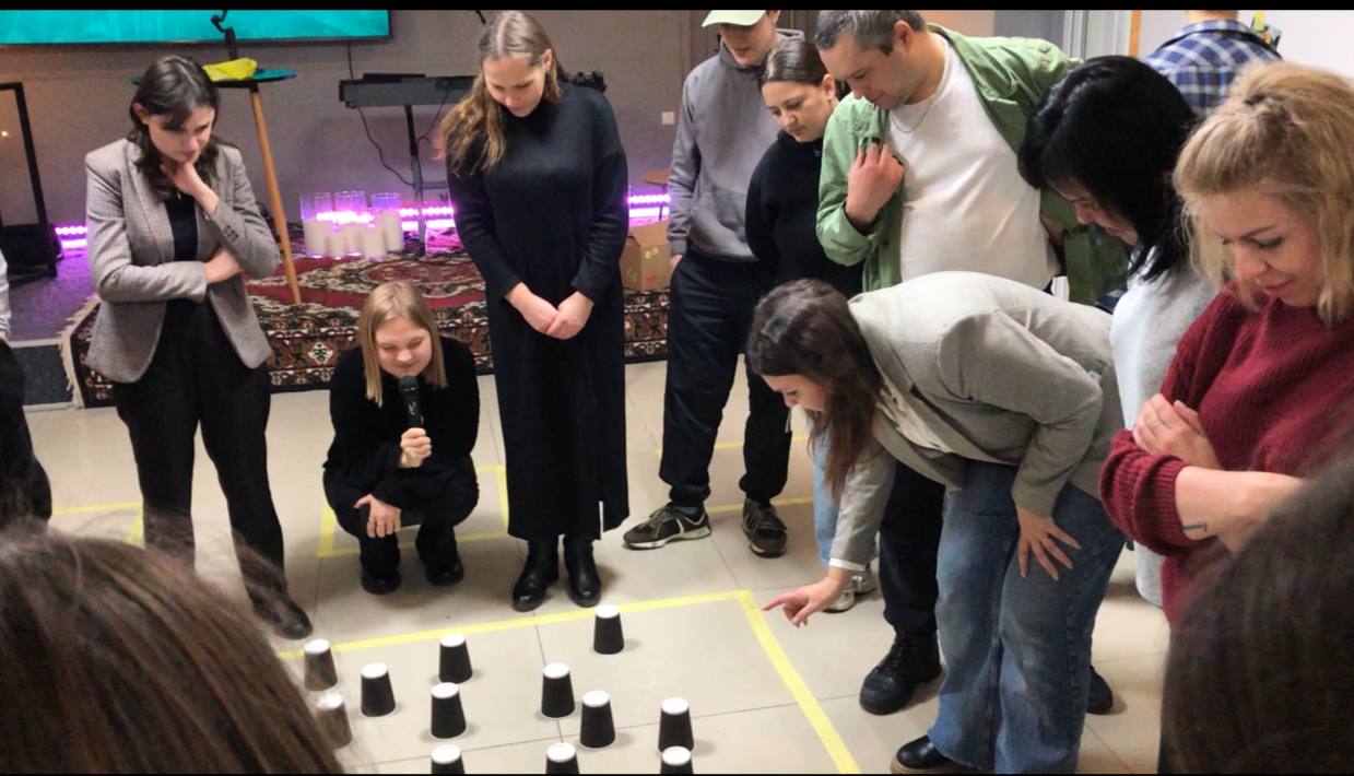 Ukrainian Volunteers Playing A Game Innvolving Cups Ukrainian Volunteers Playing A Game Innvolving Cups