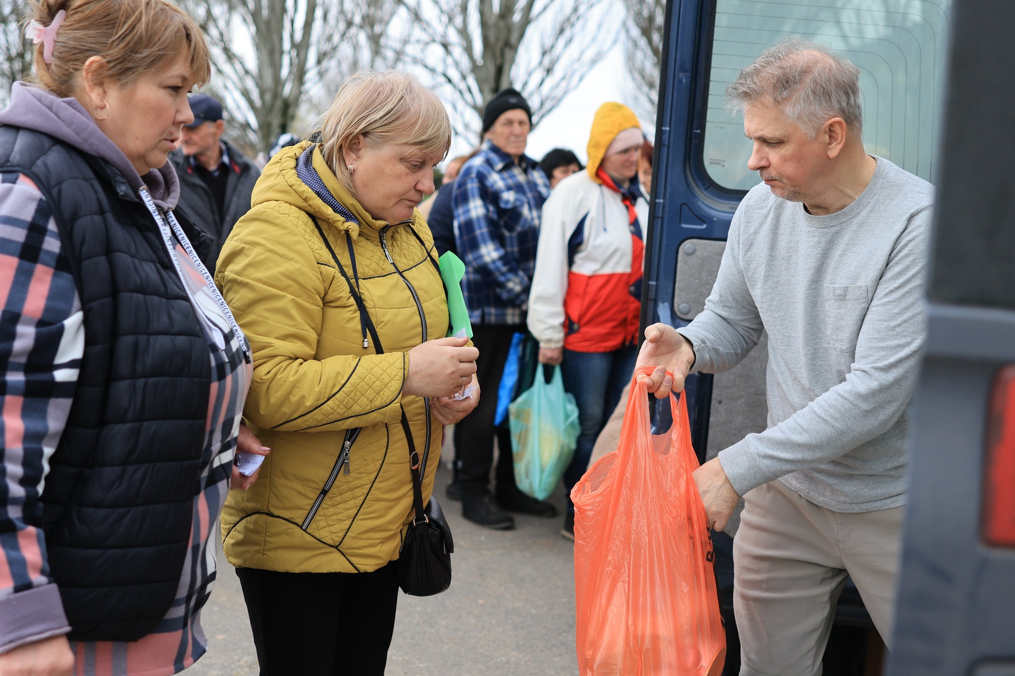 Pastor Passing Grocery Bag Of Goods Pastor Passing Grocery Bag Of Goods