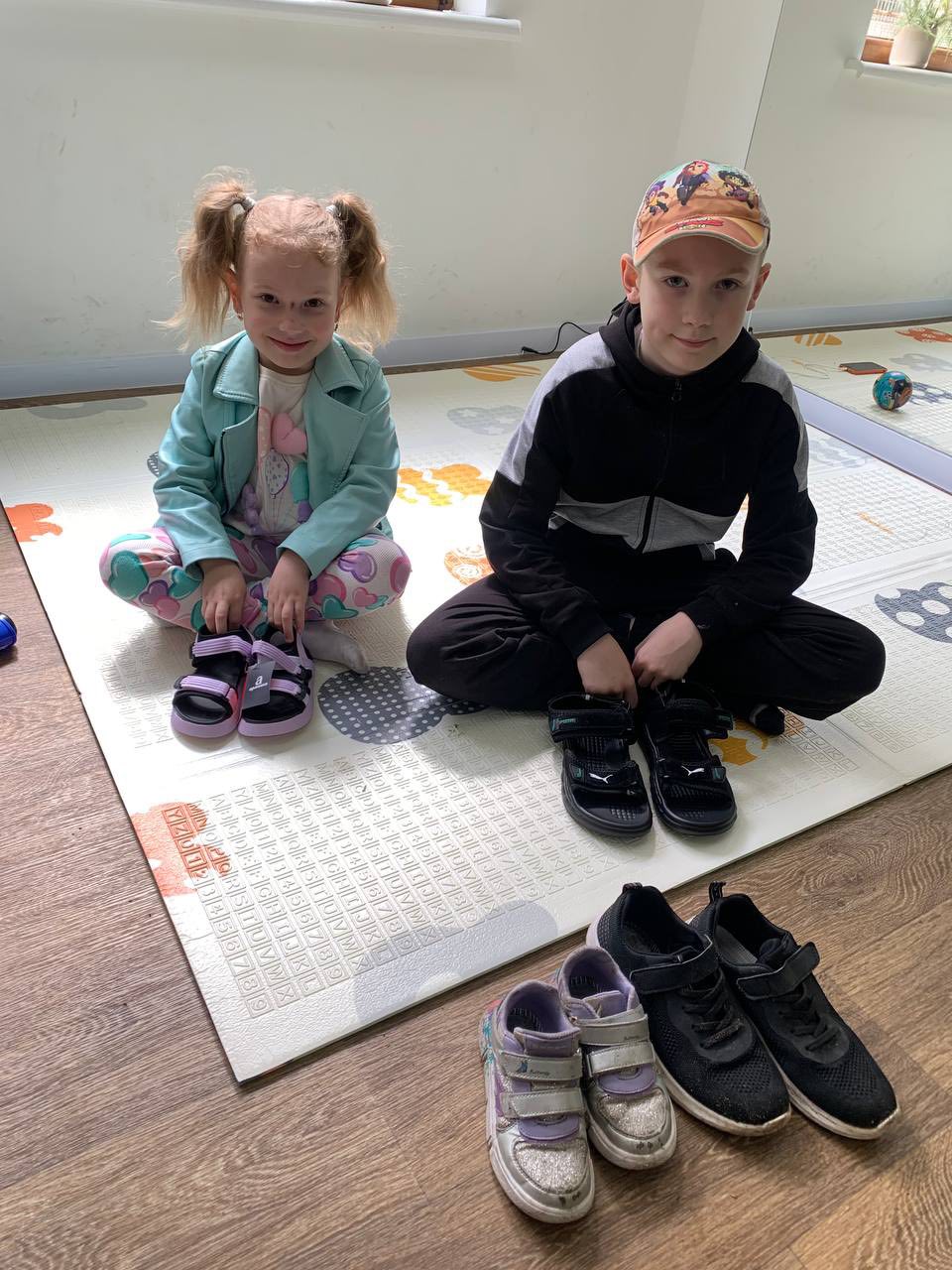Two Ukrainian Children Sitting With Their Nnew Shoes Two Ukrainian Children Sitting With Their Nnew Shoes