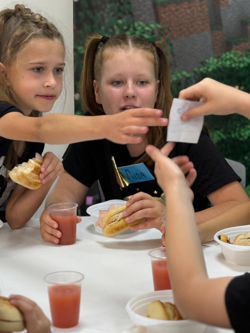 Ukrainian Girls Readinng A Small Piece Of Papaer
