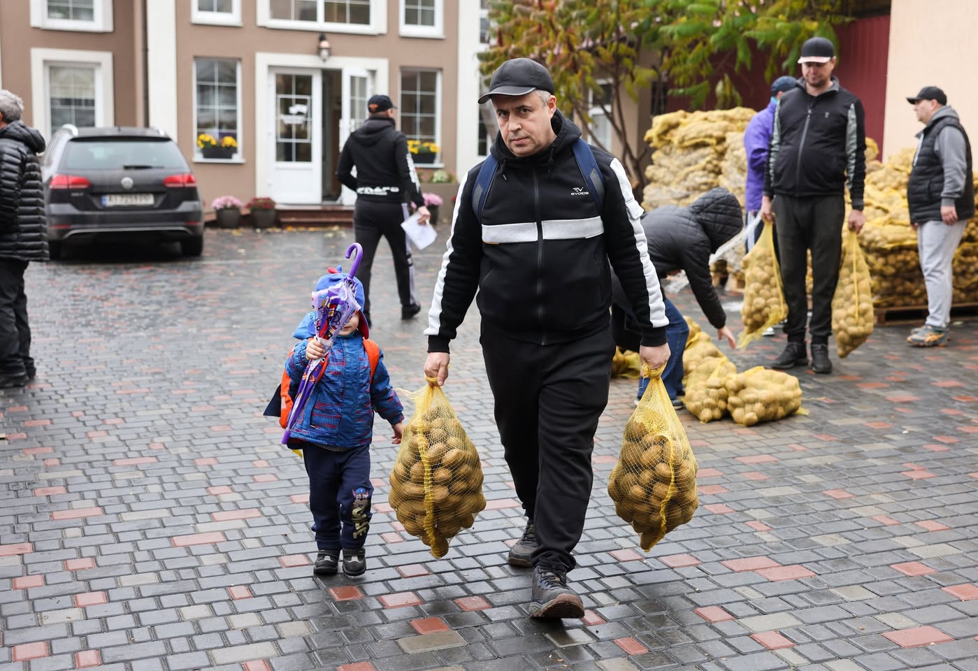 A Ukrainian Father With His Son Carrying Potatoes