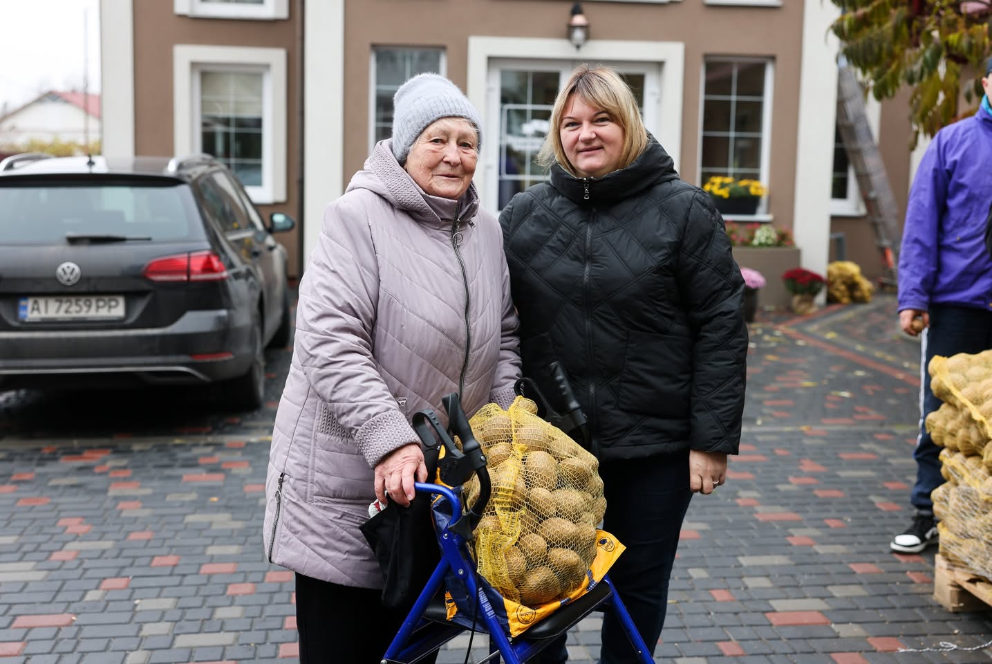 A Volunteer Giving Potatoes To An Elderly Ukrainian Woman