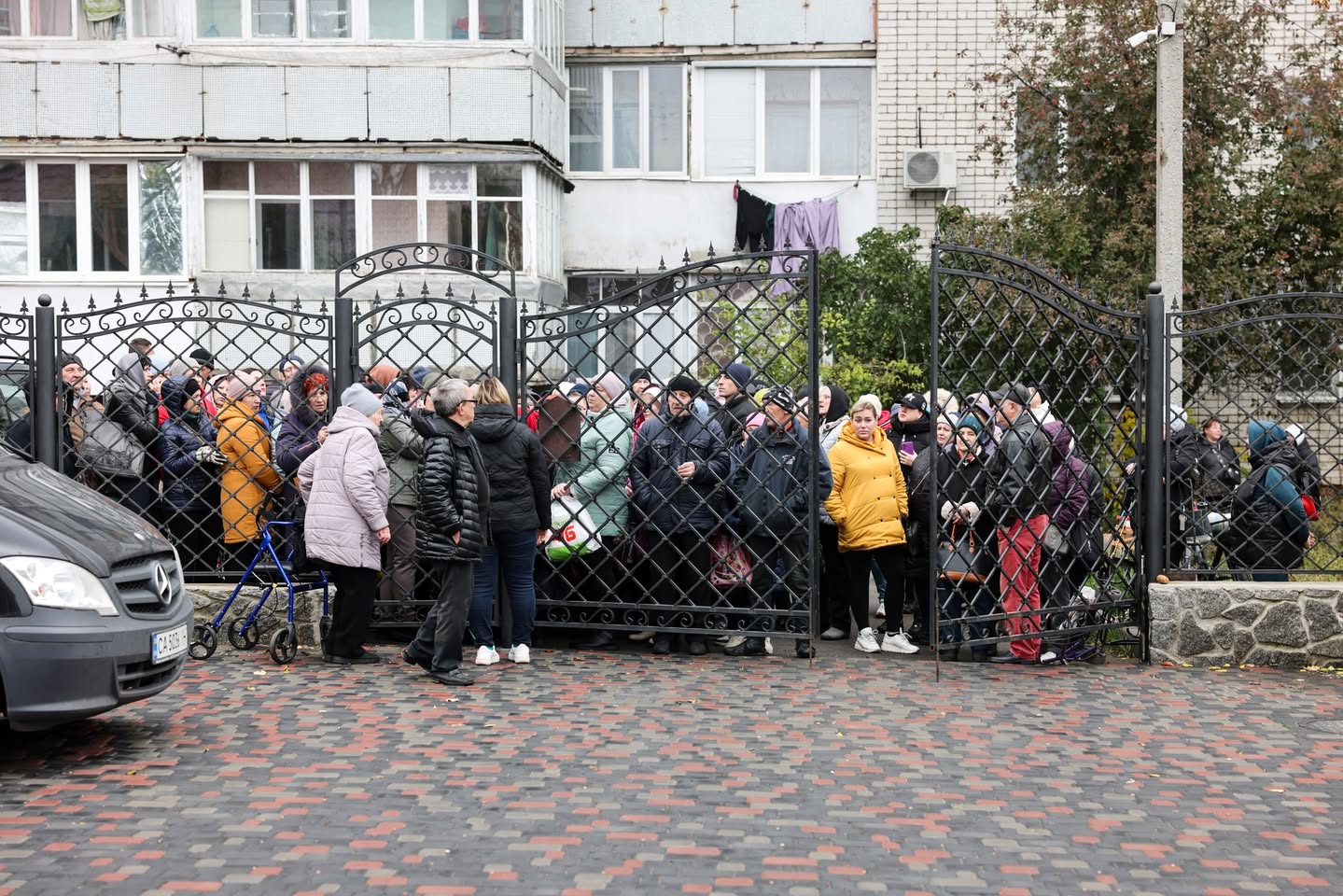 Group Of Ukrainian Refugees Gathered By A Fence