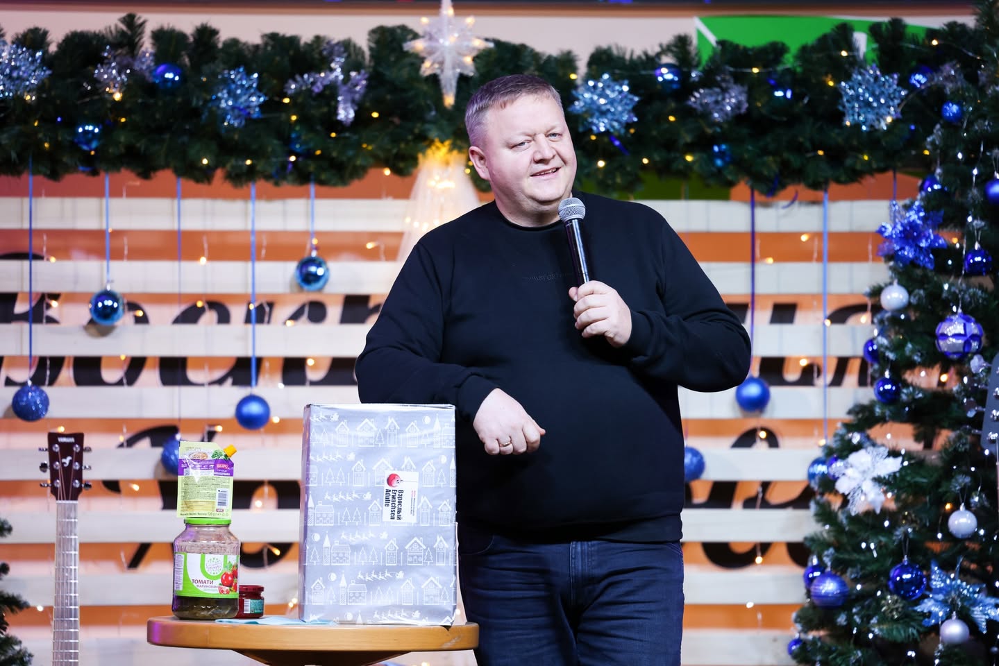 Pastor Standing With A Christmas Present