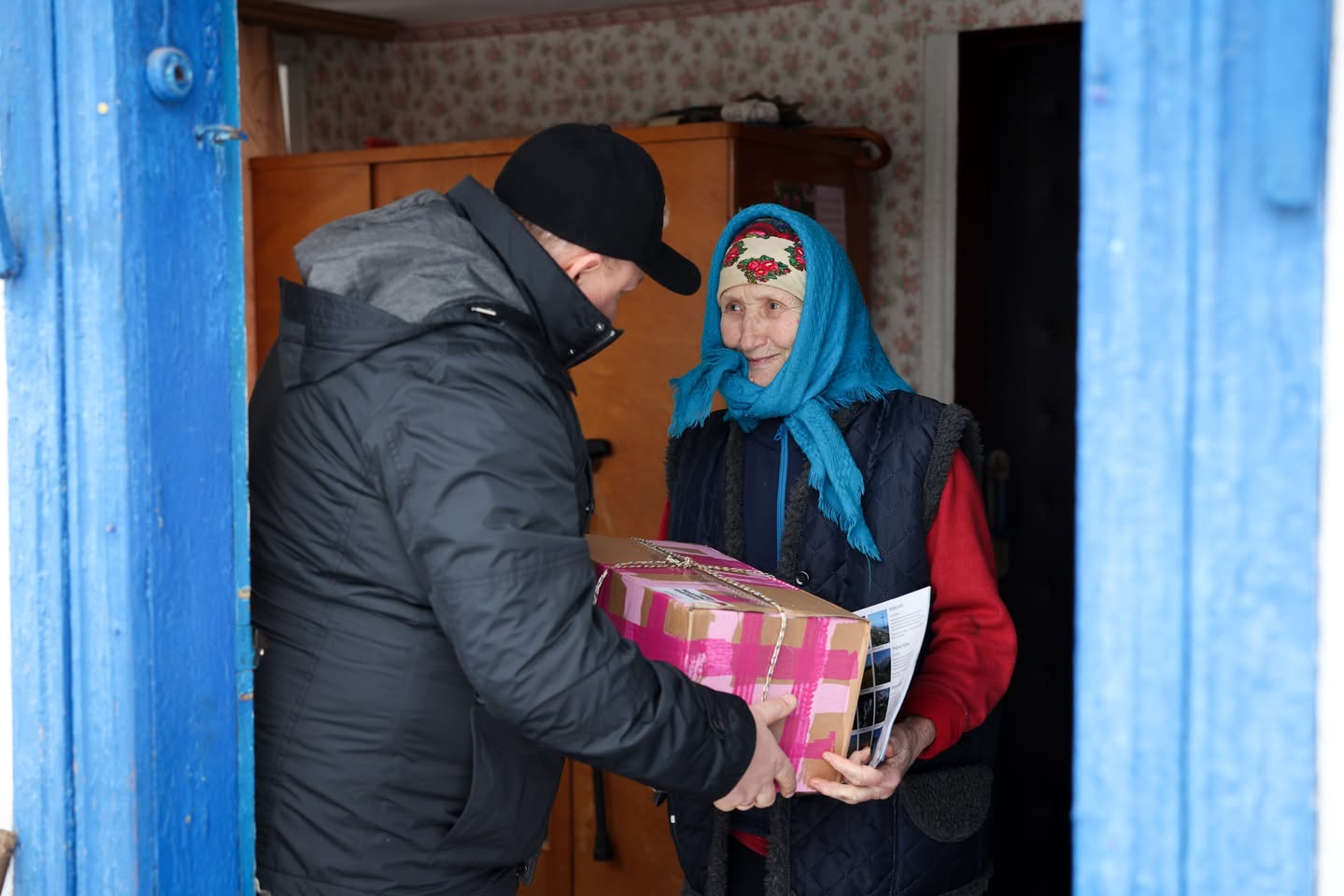 Ukrainian Pastor Giving An Elderly Ukrainian Woman A Present